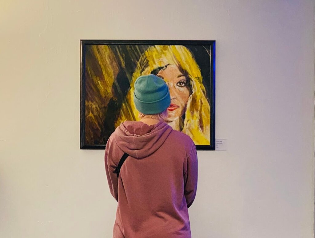 photo of a person admiring a painting